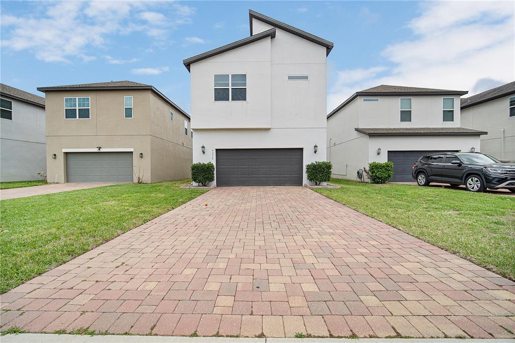A two-story white house with a paver driveway and a two-car garage — 9972 PALLIDA HICKORY WAY, WINTER GARDEN, FL