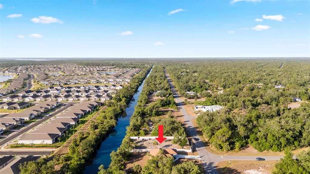 An aerial view shows a house with a red arrow pointing to its lot — 764 BOWMAN TERRACE, PORT CHARLOTTE, FL