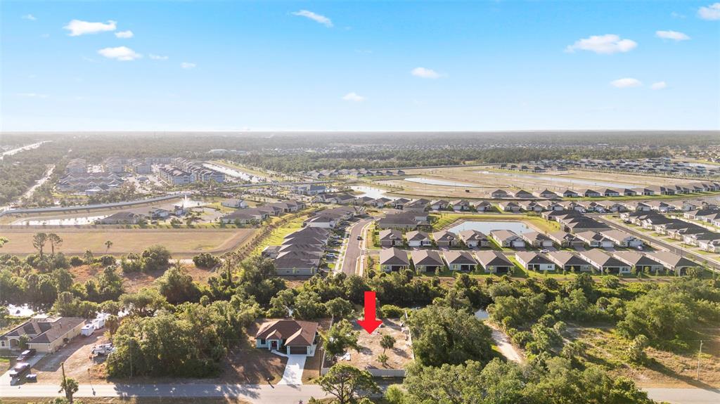 An aerial view shows a vacant residential lot next to a house in a neighborhood — 764 BOWMAN TERRACE, PORT CHARLOTTE, FL