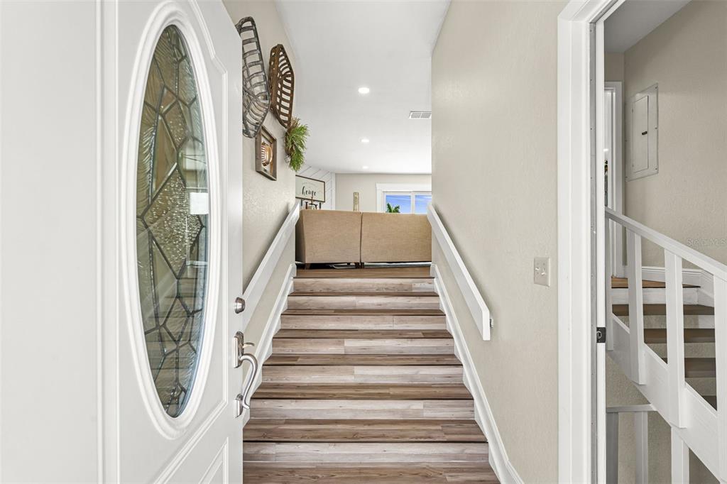 An entryway features a white front door and stairs leading up to a living area — 5404 BAY STATE ROAD, PALMETTO, FL