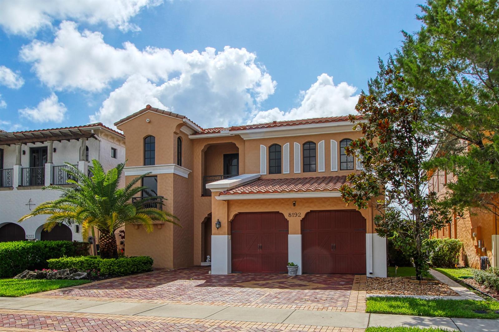 A two-story stucco house with a tile roof, two-car garage, and a brick driveway — 8192 Canopy Terrace, Parkland FL 33076, PARKLAND, FL