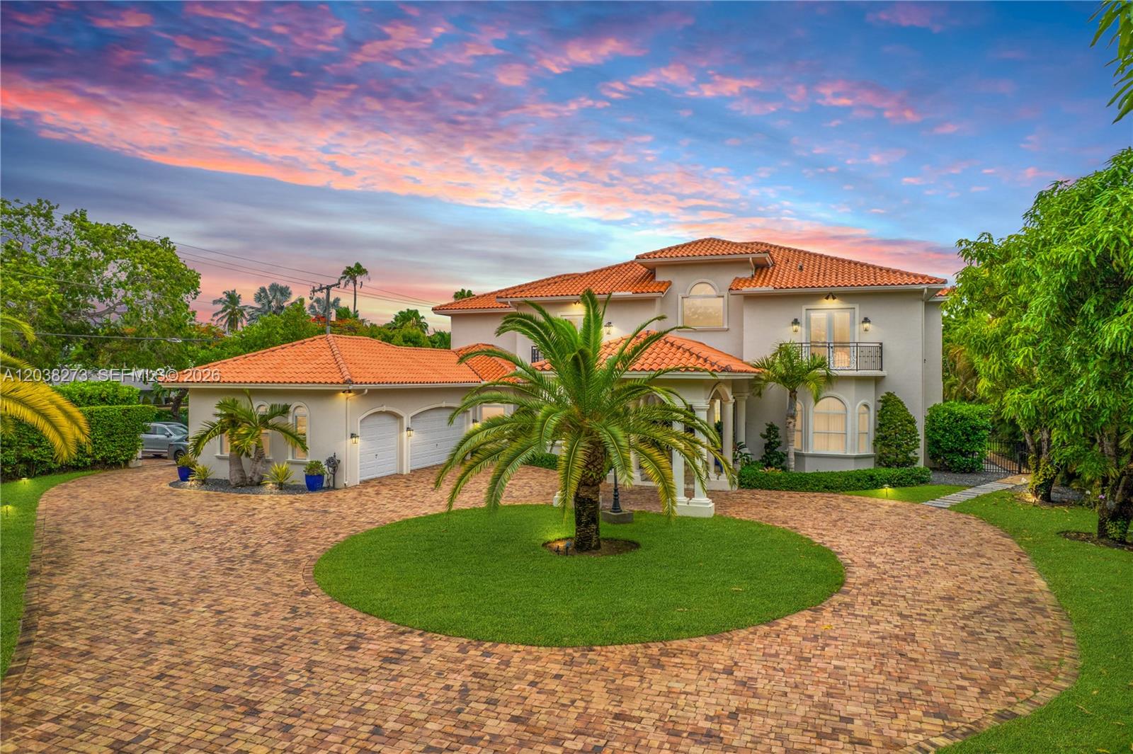 A two-story Mediterranean-style house features a circular brick driveway, a palm tree, and tile roof — 11111 SW 77th Ave, Pinecrest FL 33156, PINECREST, FL