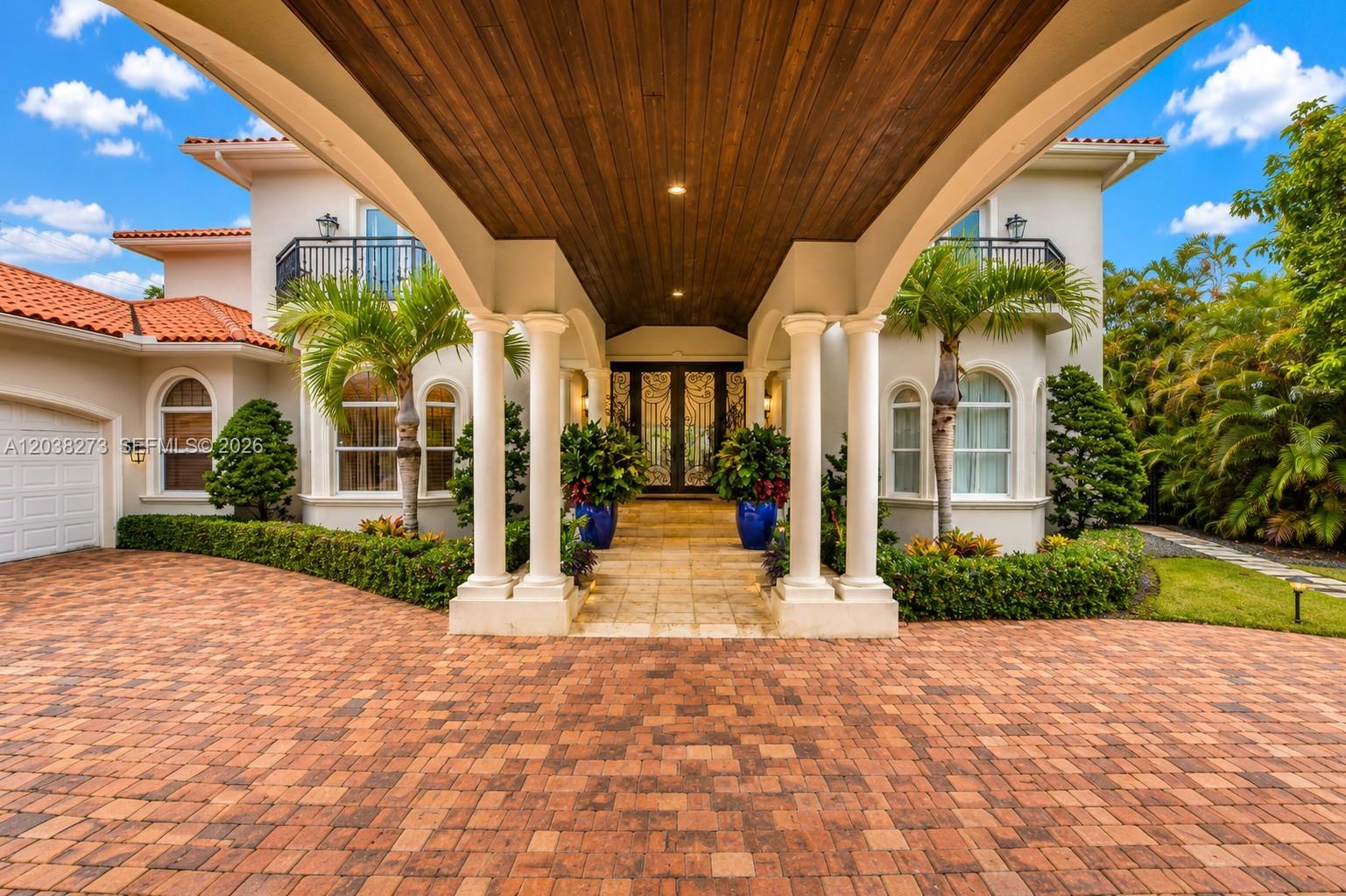 A paved driveway leads to the covered entrance of a two-story house with columns — 11111 SW 77th Ave, Pinecrest FL 33156, PINECREST, FL