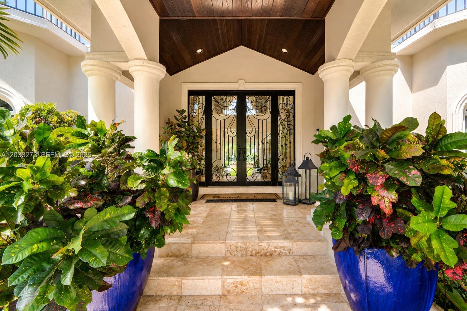 An entryway features a tiled staircase leading to a decorative black iron double door — 11111 SW 77th Ave, Pinecrest FL 33156, PINECREST, FL