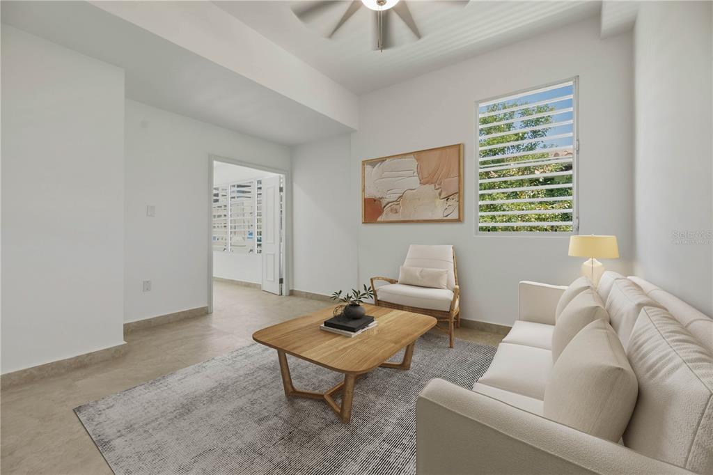 A living room features a white sofa, wooden coffee table, armchair, and a louvered window — 16 PACIFIC PLACE STREET, SAN JUAN, PR