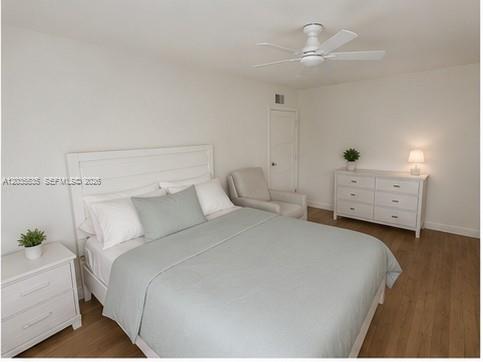 A bedroom features a white bed, a matching dresser, a ceiling fan, and wood-look flooring — 7880 SW 55th Ave # A, Miami FL 33143, MIAMI, FL
