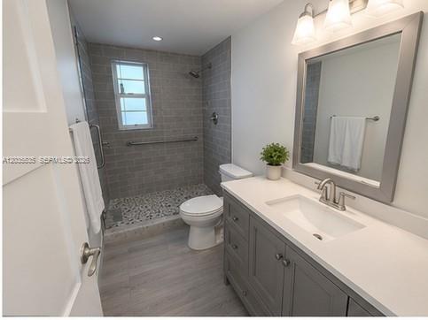 A bathroom features a gray vanity, a walk-in shower with gray tiles, and a toilet — 7880 SW 55th Ave # A, Miami FL 33143, MIAMI, FL