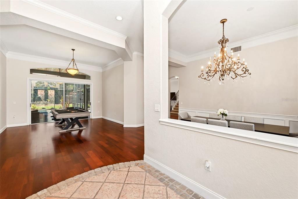 Aerial view of a house with a green roof, swimming pool, and circular driveway — 9119 BALMORAL MEWS SQ, WINDERMERE, FL