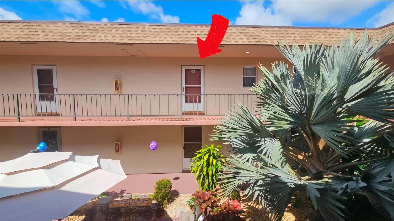 An exterior view of a two-story apartment building with a red arrow pointing to unit 96 — 504 Davis Road # 96, Palm Springs FL 33461, PALM SPRINGS, FL