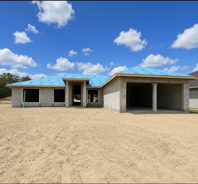 This is a rendering of a single-story suburban house with a gray exterior and garage — 685 W HALLAM DRIVE, DUNNELLON, FL