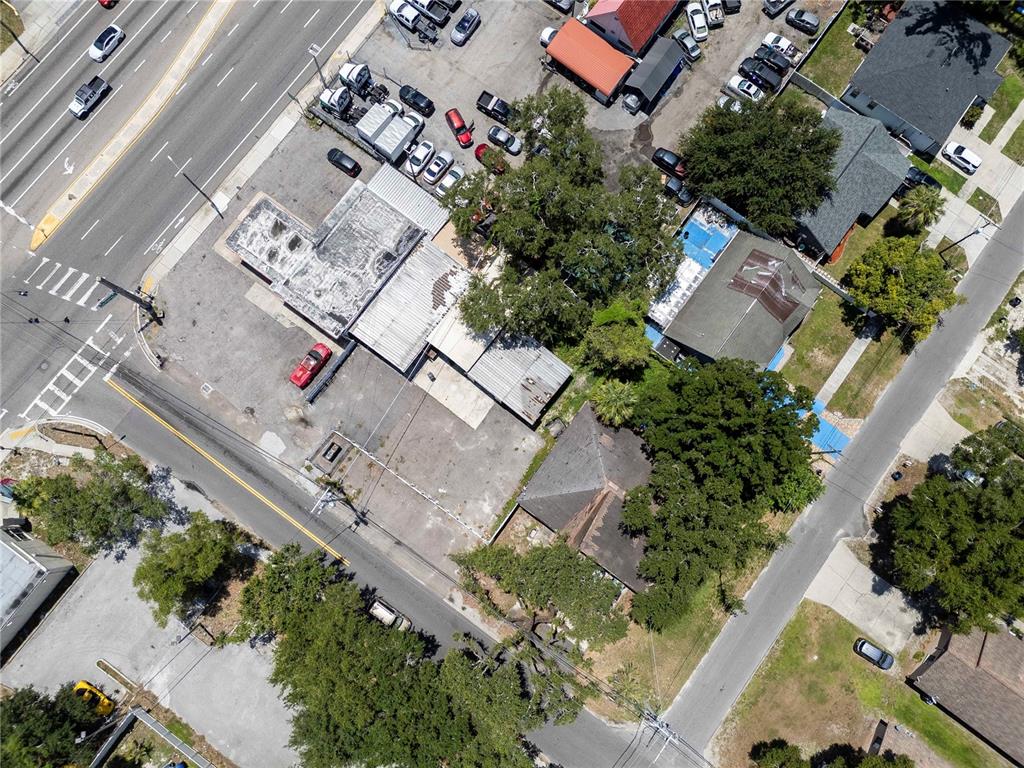 An aerial view shows a commercial building with a parking lot and surrounding trees — 8624 N FLORIDA AVENUE, TAMPA, FL