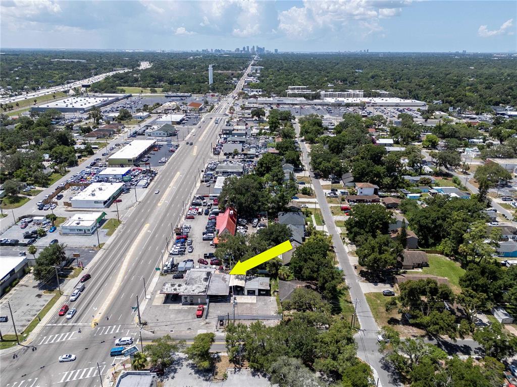 Aerial view of a commercial property with a parking lot and adjacent residential buildings — 8624 N FLORIDA AVENUE, TAMPA, FL