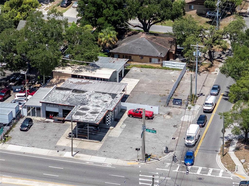 An aerial view shows a commercial building with a flat roof next to a highway — 8624 N FLORIDA AVENUE, TAMPA, FL