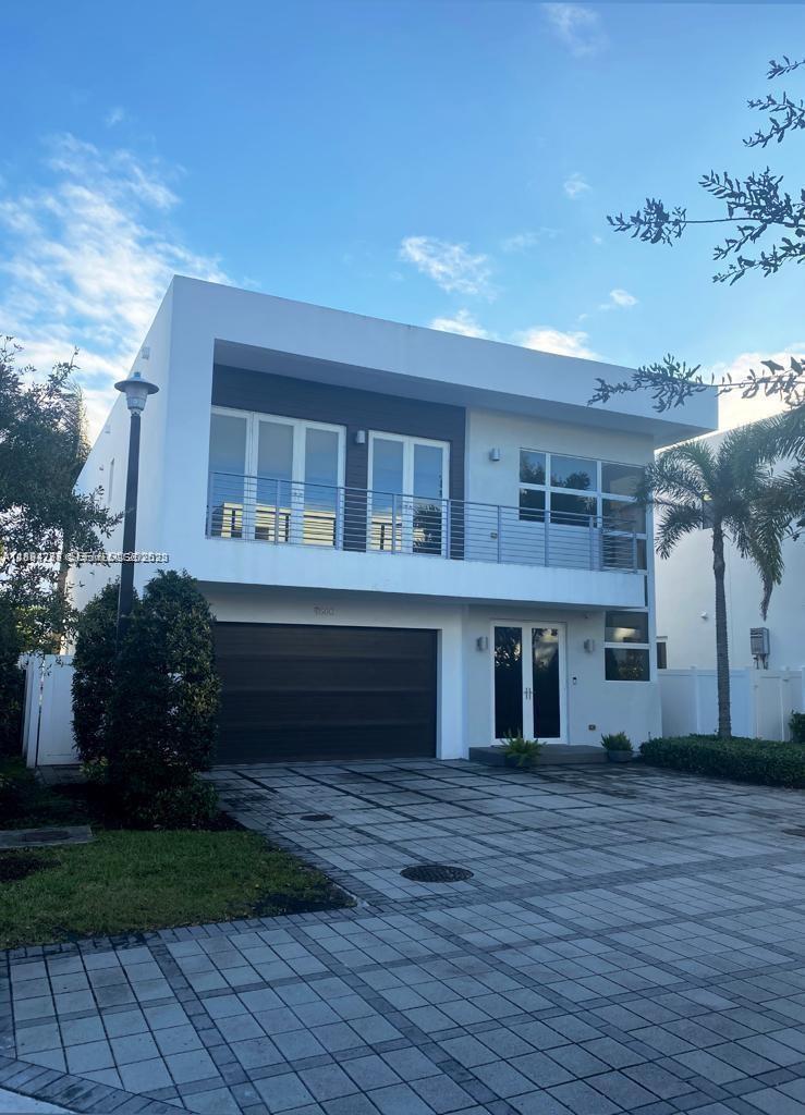 A living room with high ceilings, a black sofa, a glass coffee table, and tile flooring — 9880 NW 74th Ter, Doral FL 33178, DORAL, FL