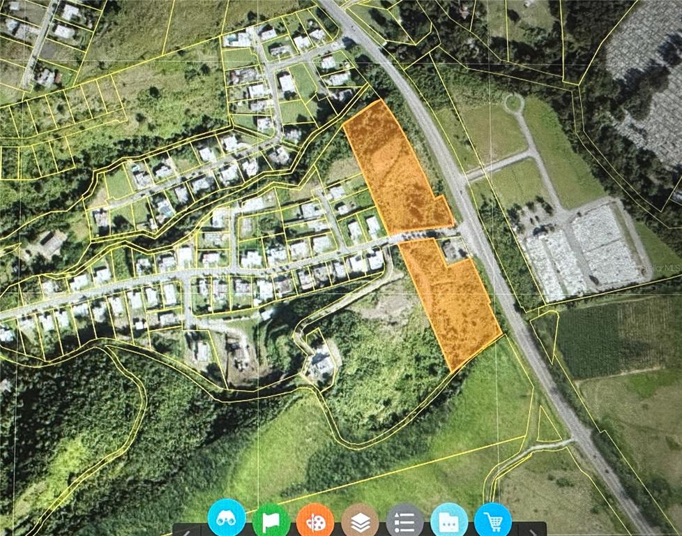 This is an aerial map showing two highlighted vacant land parcels adjacent to a road — BO. SAN IDELFONSO, COAMO, PR