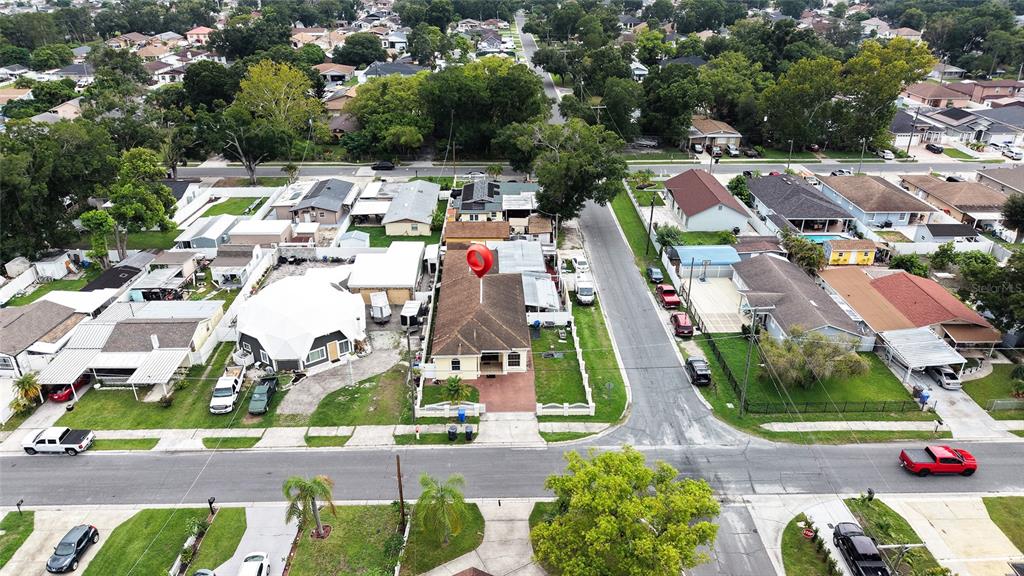 An aerial view shows a residential neighborhood with a red location pin over a house — 6922 N HALE AVENUE, TAMPA, FL