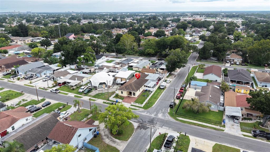 An aerial view shows a residential neighborhood with a red location pin over a house — 6922 N HALE AVENUE, TAMPA, FL