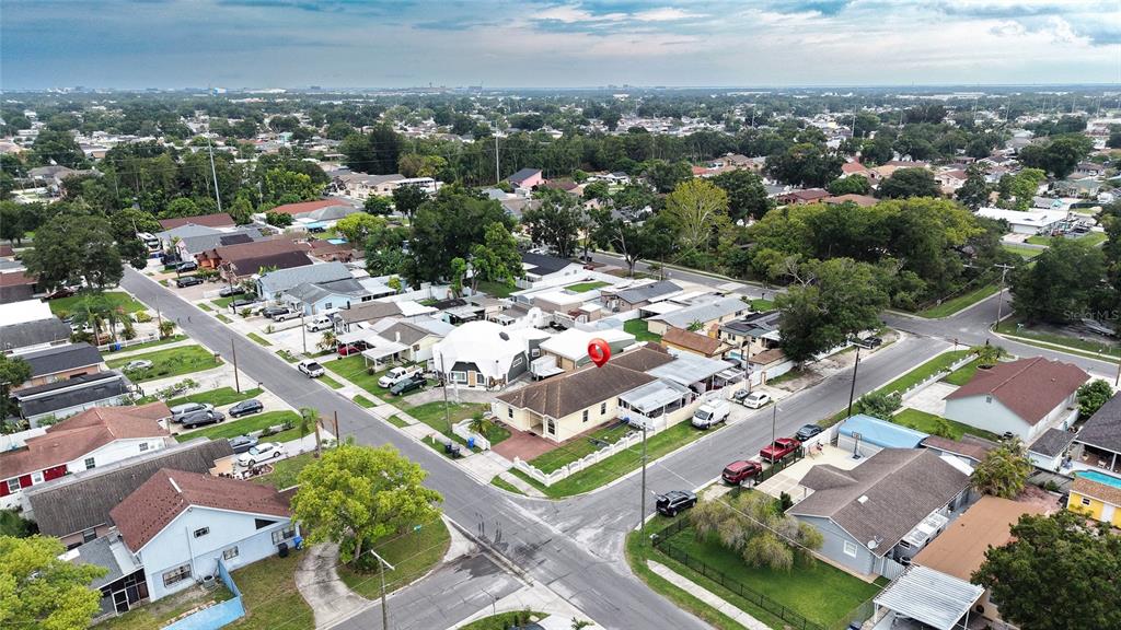 An aerial view shows a residential neighborhood with a red location pin on a house — 6922 N HALE AVENUE, TAMPA, FL