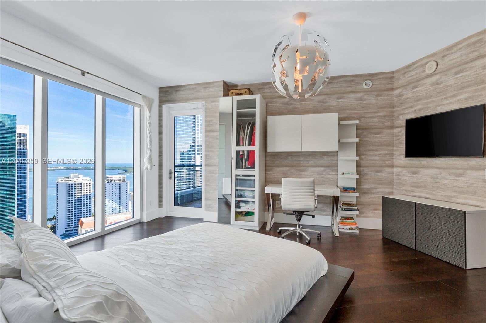 A bedroom features a platform bed, a desk area, wood-look walls, and floor-to-ceiling windows — 60 SW 13th St # 3200, Miami FL 33130, MIAMI, FL