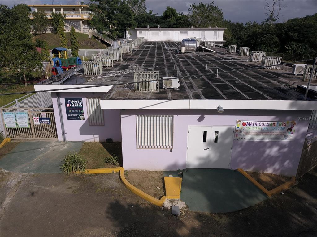 An aerial view of a light purple building with a flat roof and a playground — PR 181 Km 4.8 BO. LAS CUEVAS, TRUJILLO ALTO, PR
