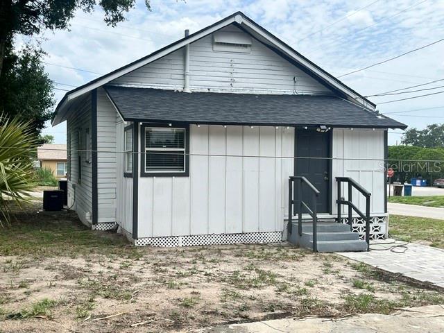 A white house with a dark roof and a small set of front steps — 118 W STUART AVENUE, LAKE WALES, FL