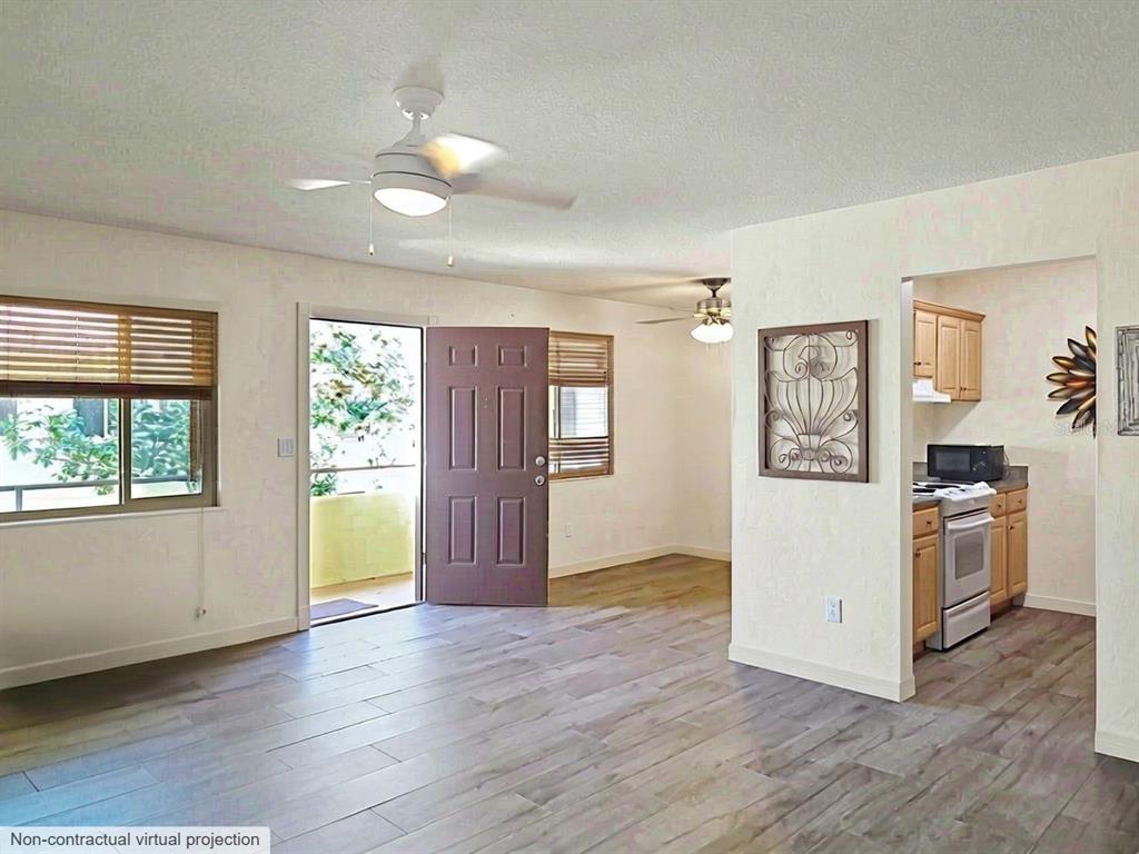This is a virtual projection of an open-concept living area with wood-look flooring and kitchen — 400 OAKRIDGE BOULEVARD UNIT 60, DAYTONA BEACH, FL