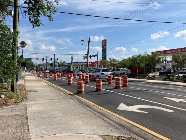 A street view shows a road under construction with orange traffic barrels lining the lanes — 103 S HOWARD AVENUE, TAMPA, FL