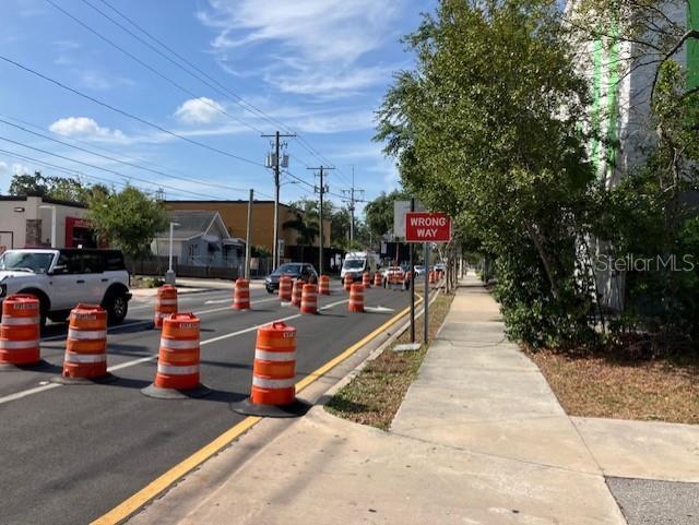 A street scene shows a road under construction with orange traffic barrels and a wrong-way sign — 103 S HOWARD AVENUE, TAMPA, FL