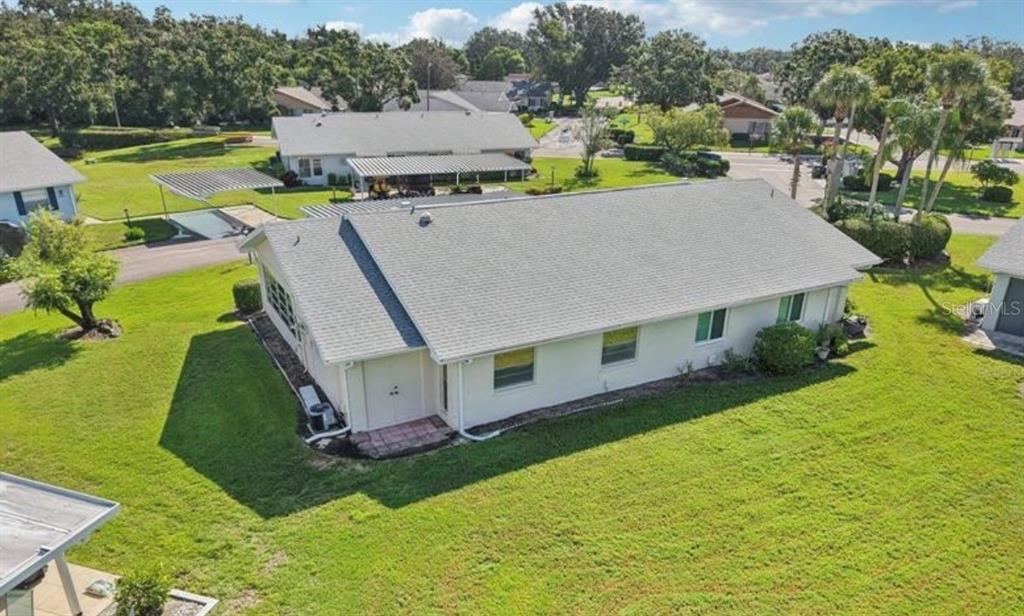 An aerial view of a white single-story house with a gray shingled roof — 2304 GLENMORE CIRCLE UNIT 327, SUN CITY CENTER, FL