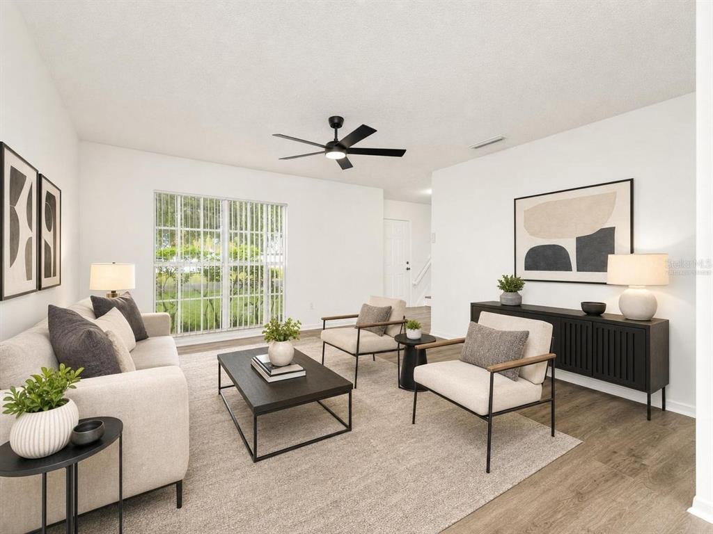 A living room features a sofa, two armchairs, a coffee table, and a ceiling fan — 9703 FOX HOLLOW ROAD, TAMPA, FL