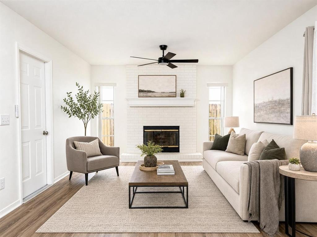 A living room features a white brick fireplace, a beige sofa, and a gray armchair — 9703 FOX HOLLOW ROAD, TAMPA, FL
