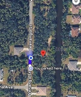 This map shows a vacant, wooded lot located along a street next to a canal — 436 E VENANGO ST STREET E UNIT 436, PORT CHARLOTTE, FL