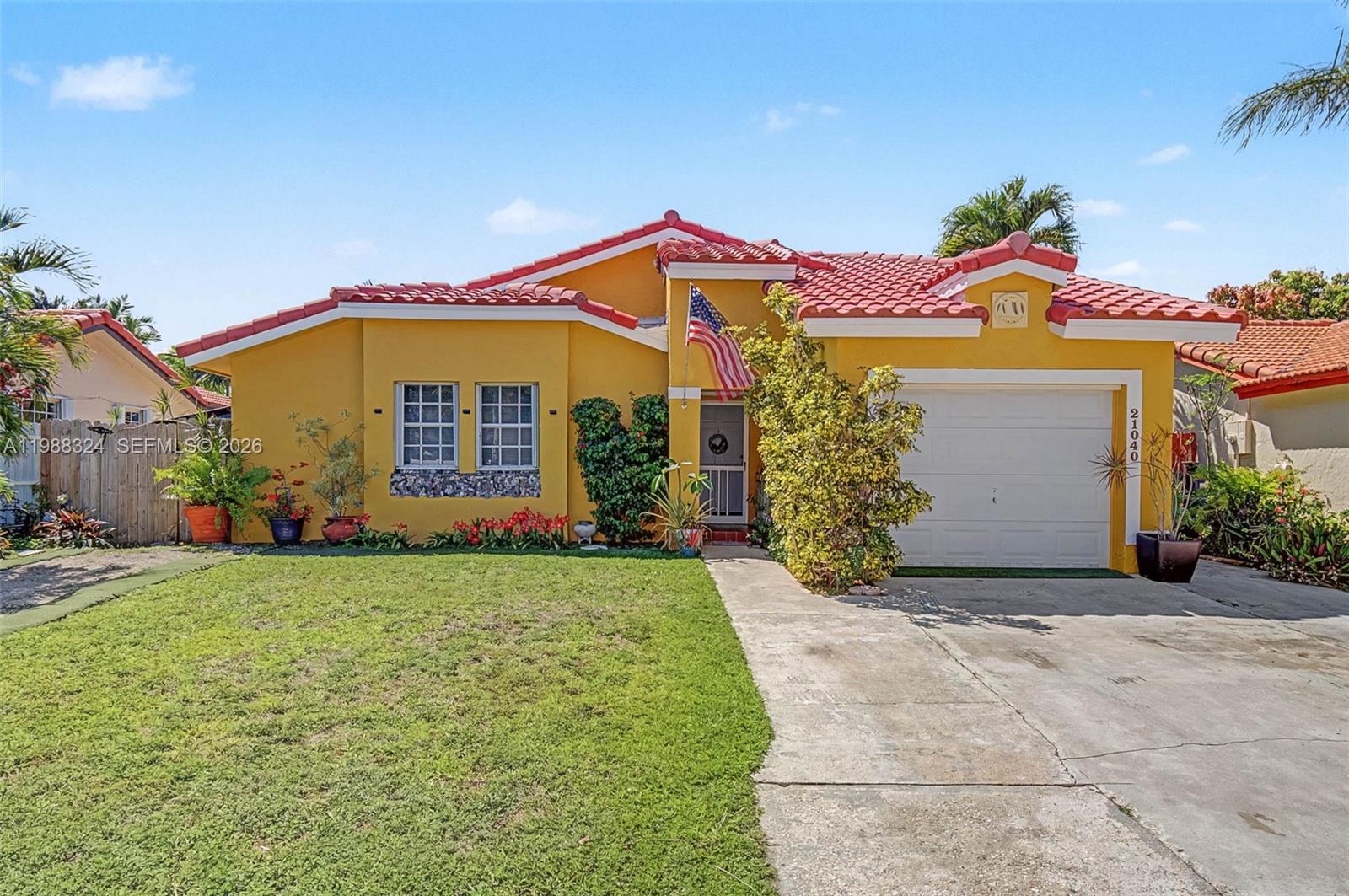 A yellow single-story house with a red tile roof and a concrete driveway — 21040 SW 85th Pass, Cutler Bay FL 33189, CUTLER BAY, FL