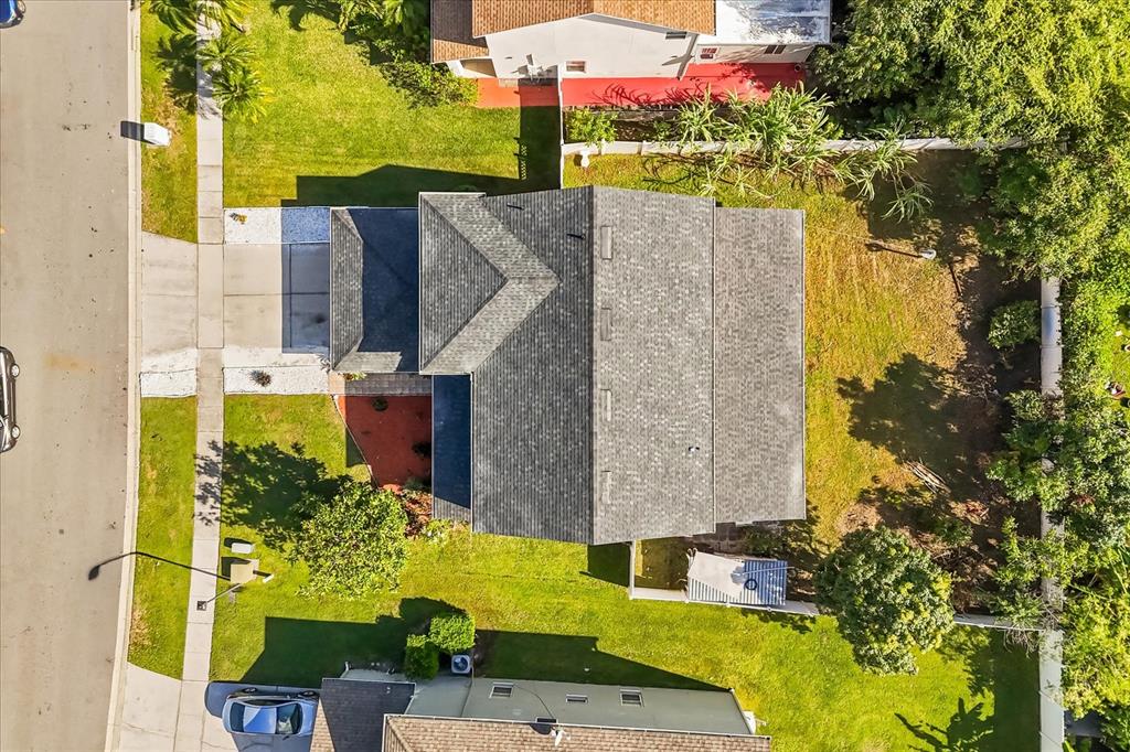 An aerial view shows a house with a gray shingled roof and a large backyard — 2530 BAYKAL DRIVE, KISSIMMEE, FL