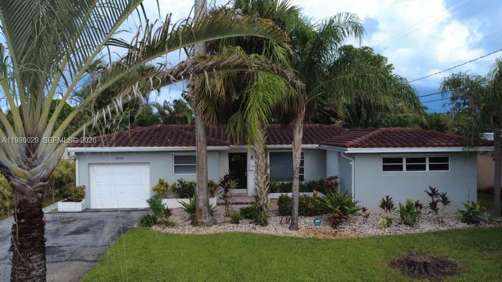 A single-story house with a gray exterior, a tiled roof, and a front-facing garage — 1419 N 16th Ct, Hollywood FL 33020, HOLLYWOOD, FL