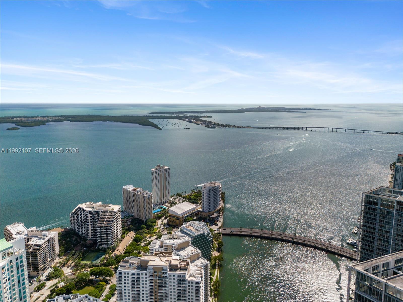 An aerial view shows high-rise buildings along a waterfront with a bridge spanning the bay — 300 Biscayne Boulevard Way # 2103C, Miami FL 33131, MIAMI, FL