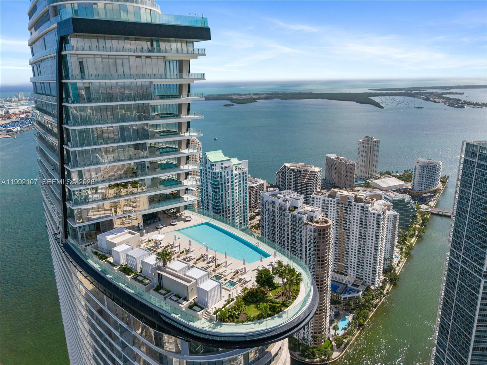 An aerial view shows a high-rise building with a large outdoor pool deck and terrace — 300 Biscayne Boulevard Way # 2103C, Miami FL 33131, MIAMI, FL