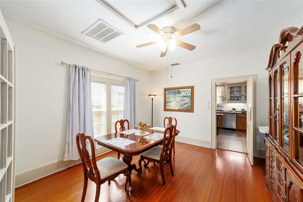 A dining room features hardwood floors, a wooden table with chairs, and a ceiling fan — 20693 WALNUT STREET, DUNNELLON, FL