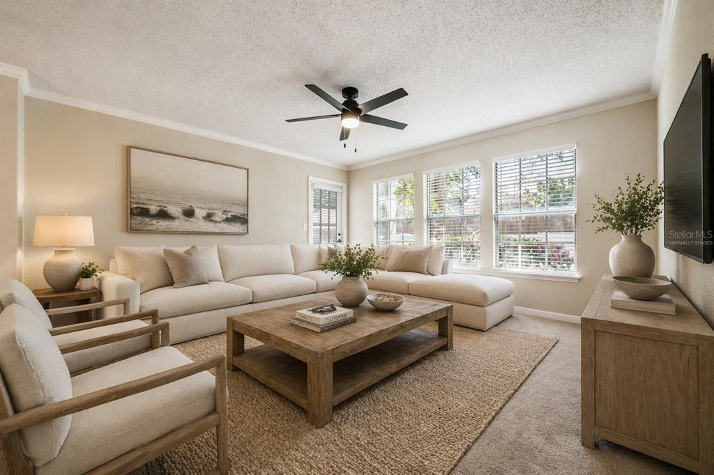 A living room features a large sectional sofa, two armchairs, a coffee table, and windows — 3274 HAVILAND COURT UNIT 101, PALM HARBOR, FL
