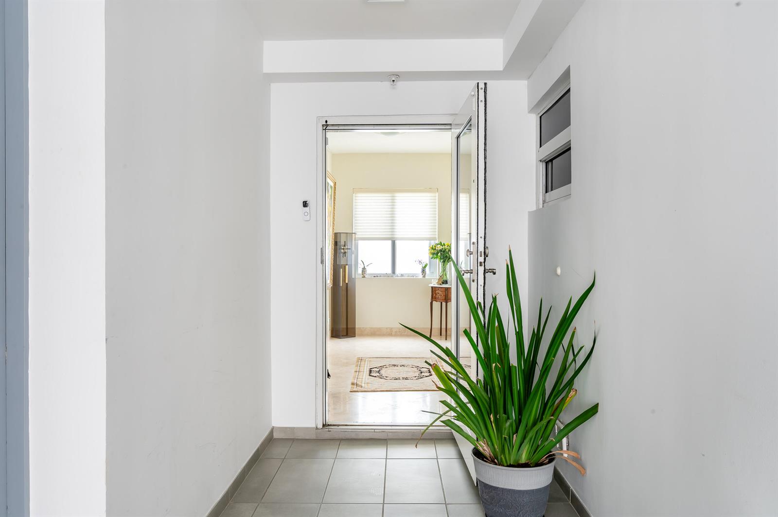 A tiled entryway leads through an open doorway into a bright room with a window — 2909 S Ocean Boulevard, Highland Beach FL 33487, HIGHLAND BEACH, FL