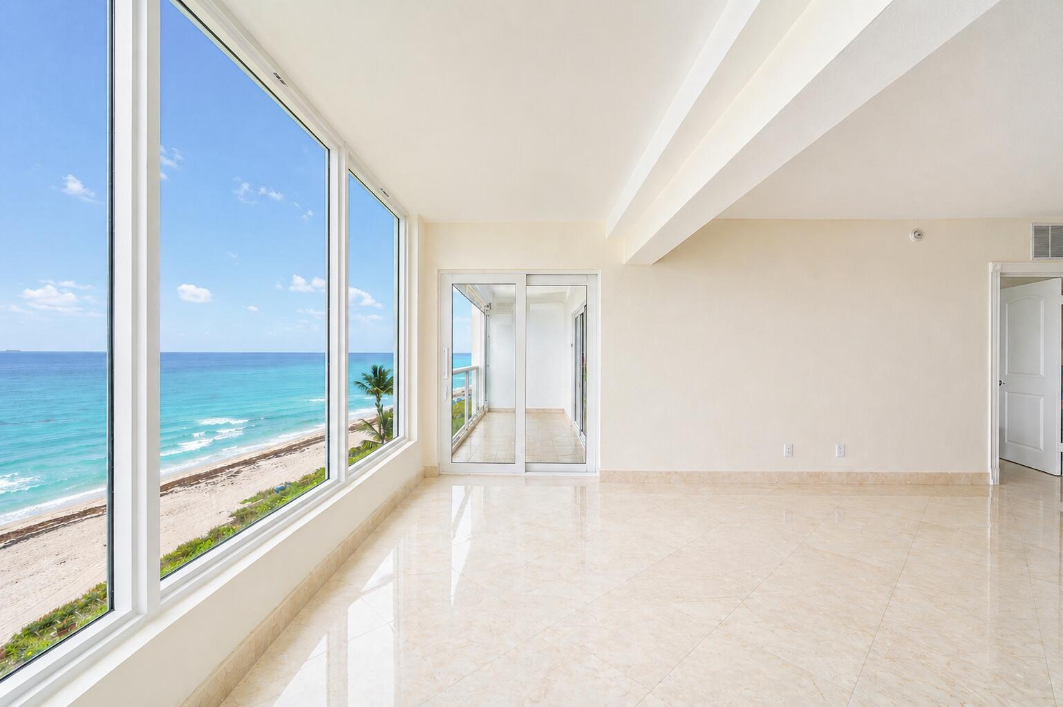 An empty room with beige tile floors, large windows overlooking the ocean, and a balcony — 2909 S Ocean Boulevard, Highland Beach FL 33487, HIGHLAND BEACH, FL
