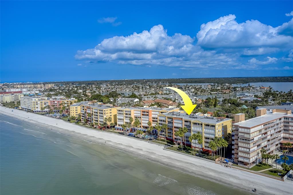 An aerial view shows a multi-story beachfront condominium complex with a yellow arrow pointing down — 16450 GULF BOULEVARD UNIT 564, NORTH REDINGTON BEACH, FL