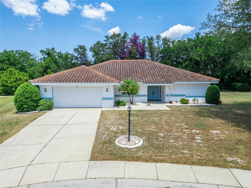 A single-story house with a tiled roof, white exterior, and a two-car garage — 2015 BERRY ROBERTS DRIVE, SUN CITY CENTER, FL