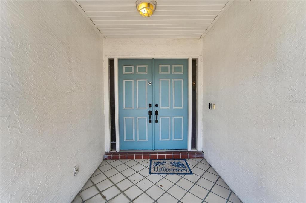 A covered entryway features a blue double door with sidelights and a tiled floor — 2015 BERRY ROBERTS DRIVE, SUN CITY CENTER, FL