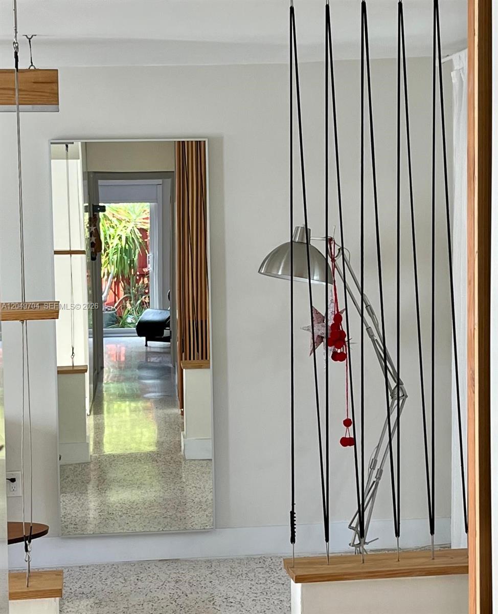 A living room features a gray sofa, a wooden coffee table, and a desk area — 451 SW 24th Rd # 2, Miami FL 33129, MIAMI, FL