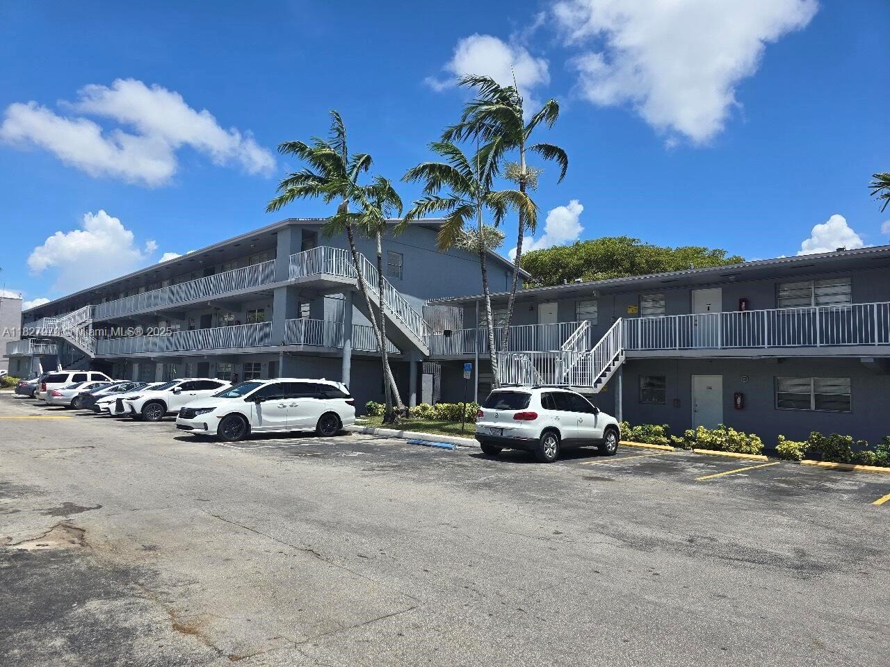 A two-story apartment building with exterior walkways and a parking lot in front — 1401 NW 103rd St # 139, Miami FL 33147, MIAMI, FL