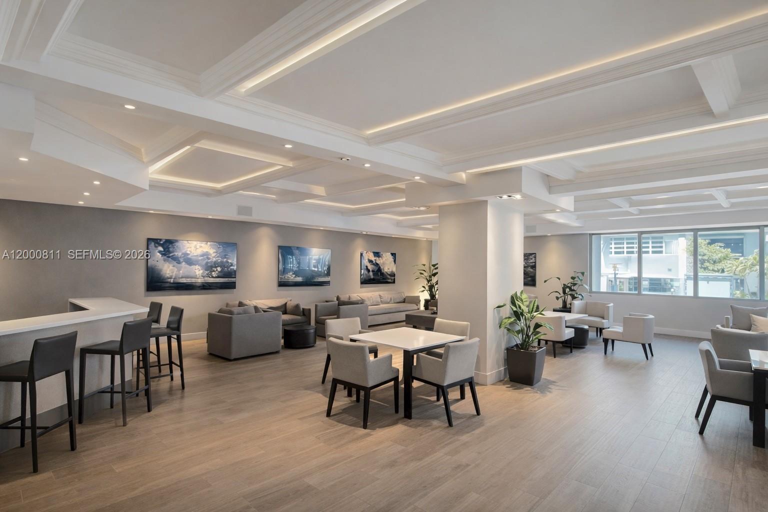 This modern lounge area features a bar, multiple seating arrangements, and a coffered ceiling — 100 Lincoln Rd # 1405, Miami Beach FL 33139, MIAMI BEACH, FL