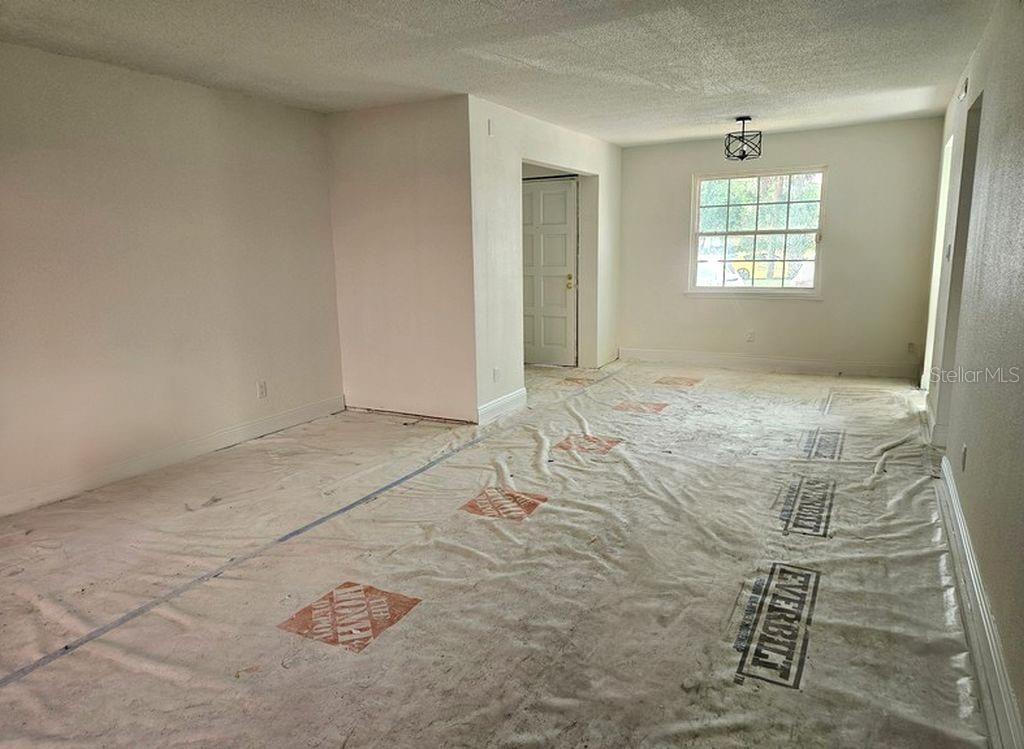 An empty room with white walls, a window, and a protective floor covering — 200 COUNTRY CLUB DRIVE UNIT 1101, LARGO, FL