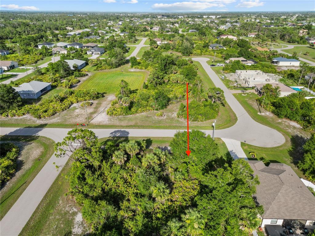 An aerial view shows a vacant, wooded residential lot marked by a red arrow — 168 WHITE PINE DRIVE, ROTONDA WEST, FL