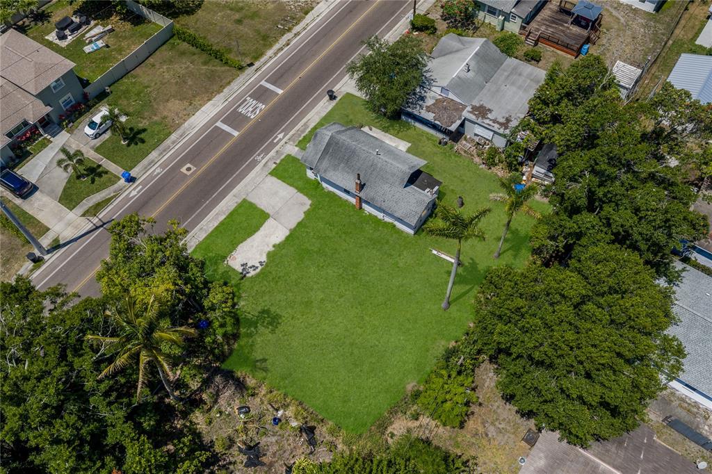 An aerial view shows a house with a large grassy yard next to a road — 15TH AVENUE S, ST PETERSBURG, FL
